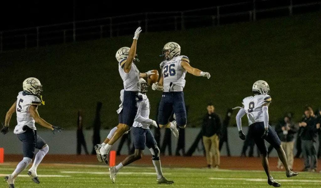 Montana State's Tre Webb and Rylan Ortt (26) jump in celebration after Webb's interception during Saturday's FCS quarterfinal game against Sam Houston at Bowers Stadium in Huntsville, Texas. 