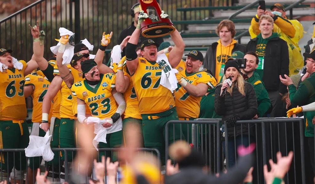 Cordell Volson lifts the FCS championship trophy