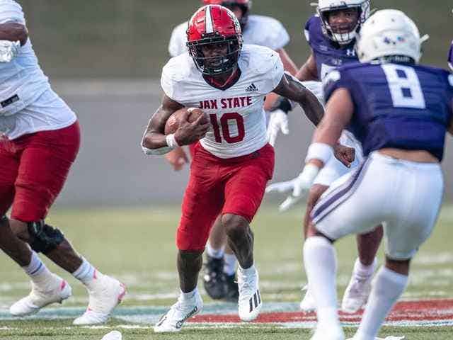 Jacksonville State's Zion Webb tucks the ball and runs against Stephen F. Austin during their August 27th, 2022 matchup.