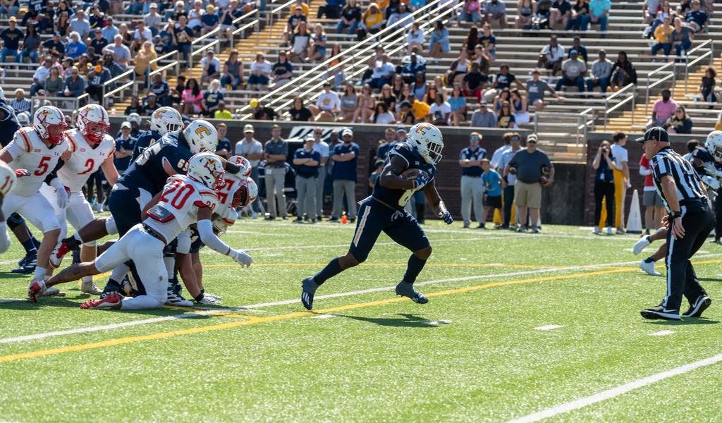UTC's Appleberry runs away from VMI defenders during their 41-13 victory over VMI