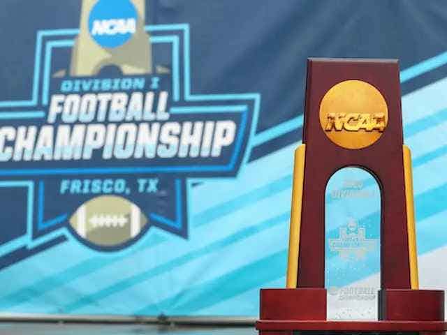 FCS Championship trophy in front of Division I Football Championship banner in Frisco, Tx